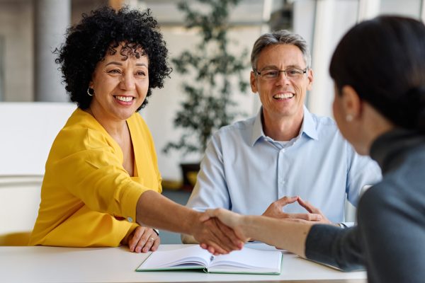 Portrait of  a young businesswoman and businessman shaking hands introducing each other during a meeting or conference in the office